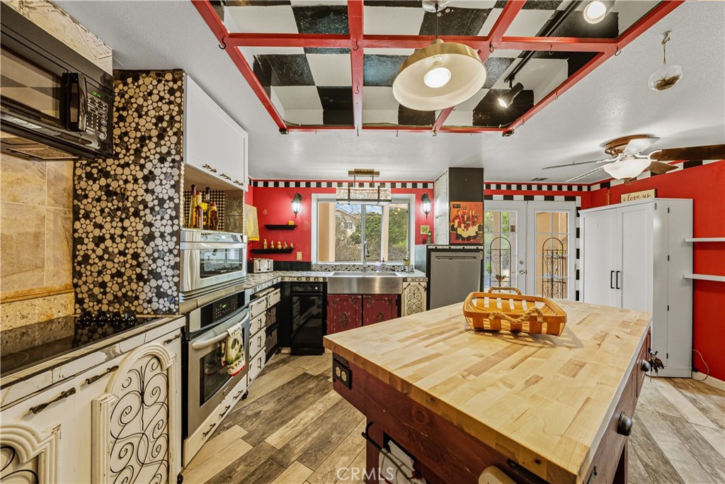 1320-1320 Stonebrook Drive Lompoc, CA 93436 - Photo 30 of 72 a kitchen with stainless steel appliances kitchen island granite countertop a stove a sink and a microwave