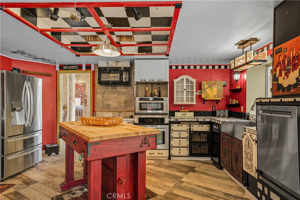 1320-1320 Stonebrook Drive Lompoc, CA 93436 - Photo 31 of 72 a kitchen with stainless steel appliances granite countertop a stove and a refrigerator