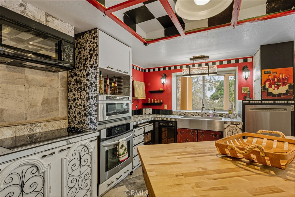 1320-1320 Stonebrook Drive Lompoc, CA 93436 - Photo 32 of 72 a kitchen with a stove a sink and a microwave