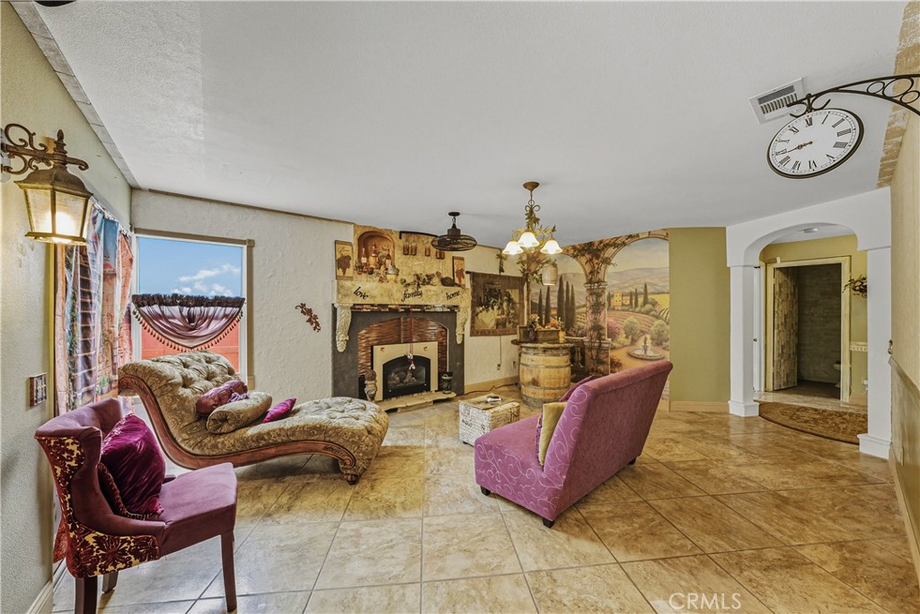 1320-1320 Stonebrook Drive Lompoc, CA 93436 - Photo 36 of 72 a living room with furniture a rug and a fireplace