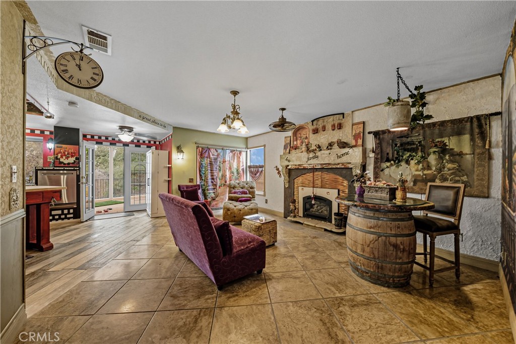 1320-1320 Stonebrook Drive Lompoc, CA 93436 - Photo 38 of 72 a living room with furniture a fireplace and a large mirror