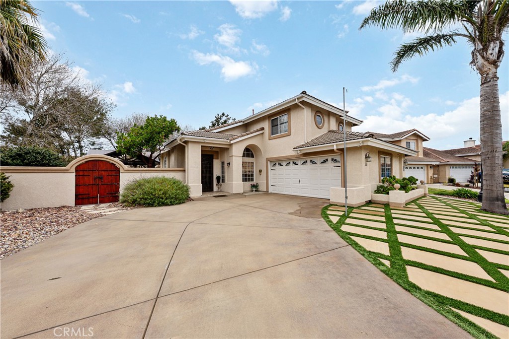 1320-1320 Stonebrook Drive Lompoc, CA 93436 - Photo 5 of 72 a front view of a house with a yard and garage