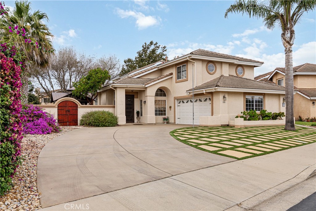1320-1320 Stonebrook Drive Lompoc, CA 93436 - Photo 8 of 72 a front view of a house with a yard and garage