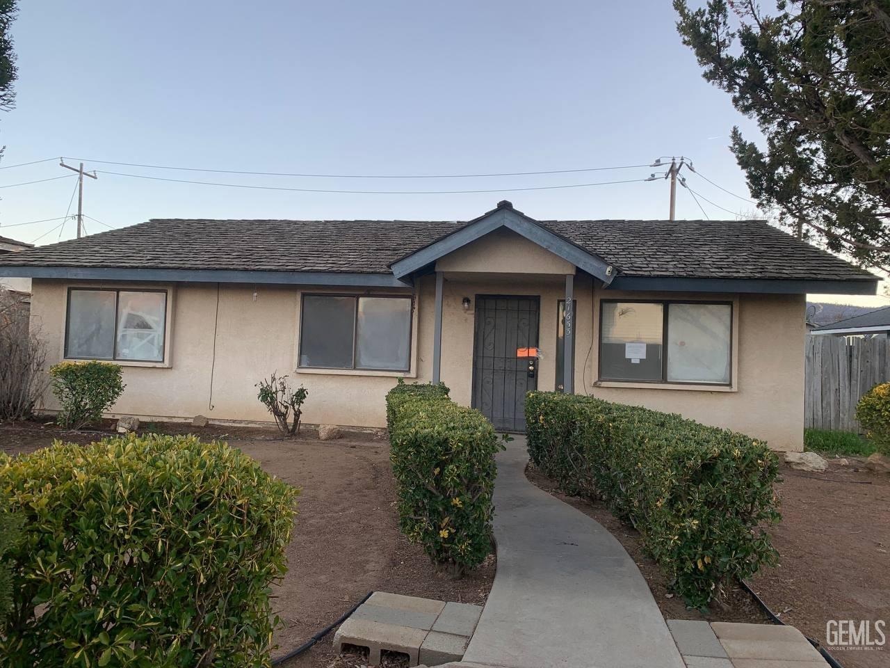 Undisclosed Address Tehachapi, CA 93561 - Photo 1 of 10 a front view of a house with garden