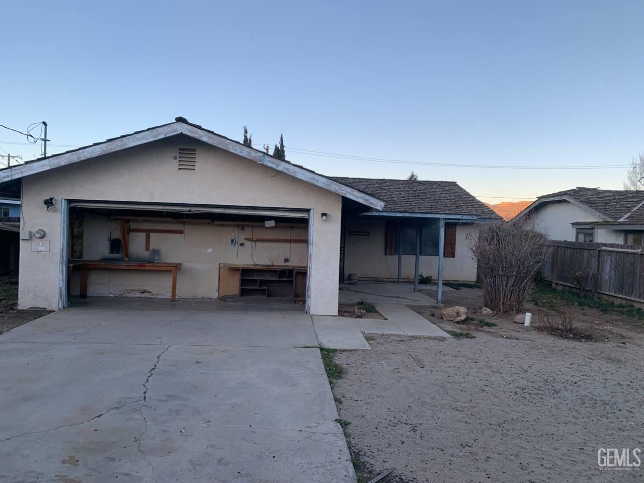 Undisclosed Address Tehachapi, CA 93561 - Photo 4 of 10 a view of a house with a yard and garage