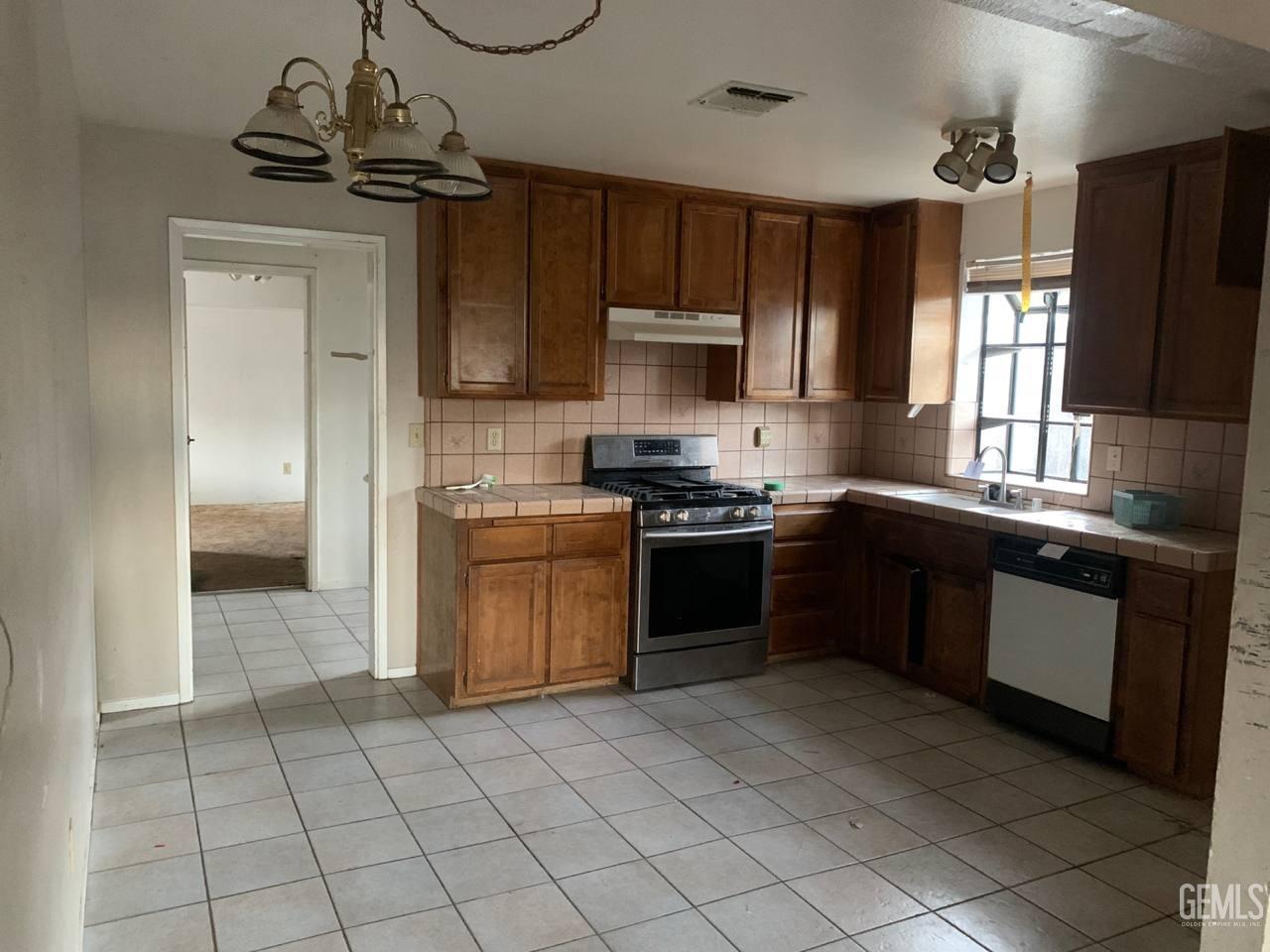 Undisclosed Address Tehachapi, CA 93561 - Photo 5 of 10 a kitchen with a sink stove and refrigerator