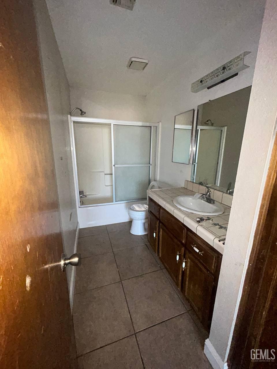 Undisclosed Address Tehachapi, CA 93561 - Photo 7 of 10 a spacious bathroom with a granite countertop sink a toilet and mirror
