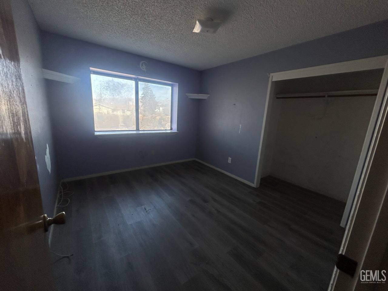 Undisclosed Address Tehachapi, CA 93561 - Photo 9 of 10 an empty room with wooden floor and windows