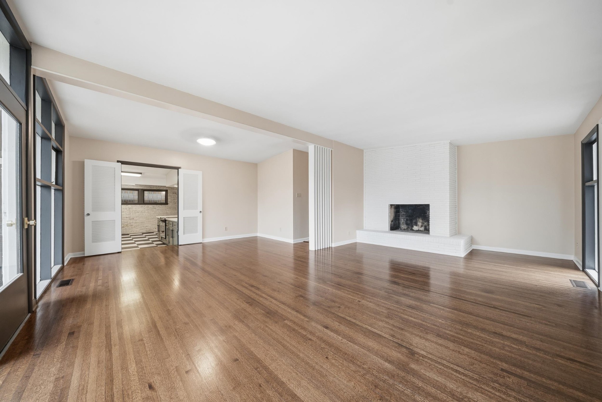 2534 Elmore Park Road Memphis, TN 38134 - Photo 13 of 35 a view of an empty room with wooden floor and a window
