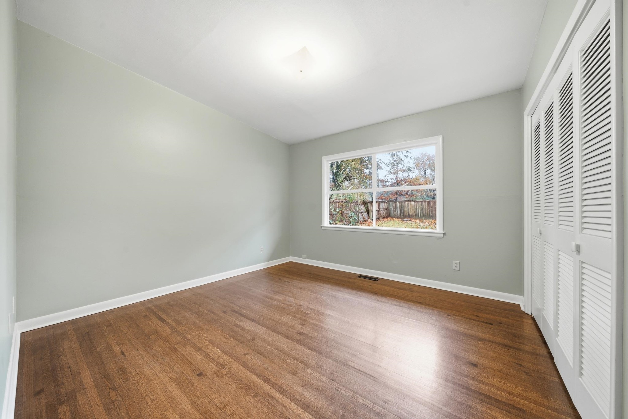 2534 Elmore Park Road Memphis, TN 38134 - Photo 25 of 35 an empty room with wooden floor and windows