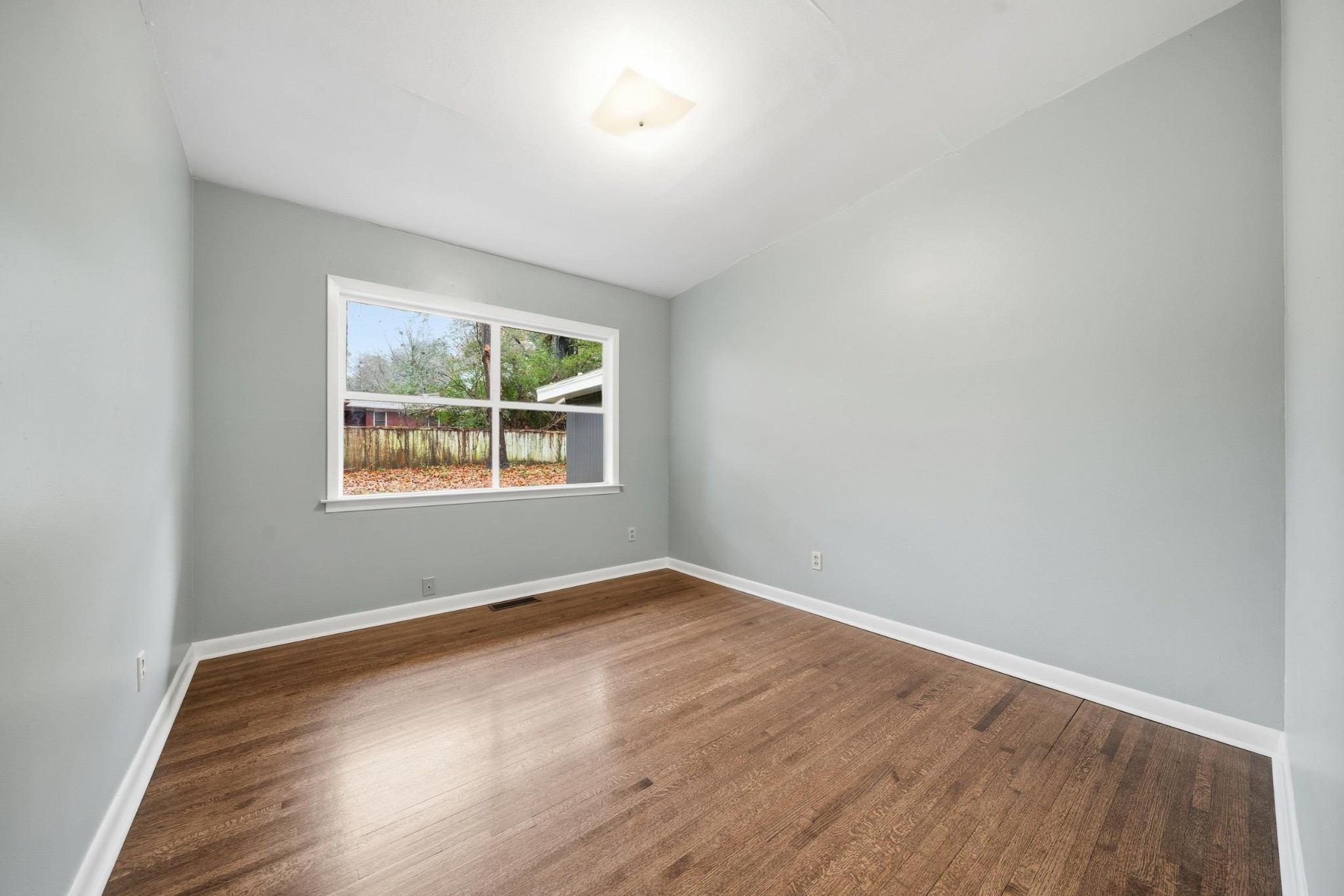 2534 Elmore Park Road Memphis, TN 38134 - Photo 27 of 35 an empty room with wooden floor and windows