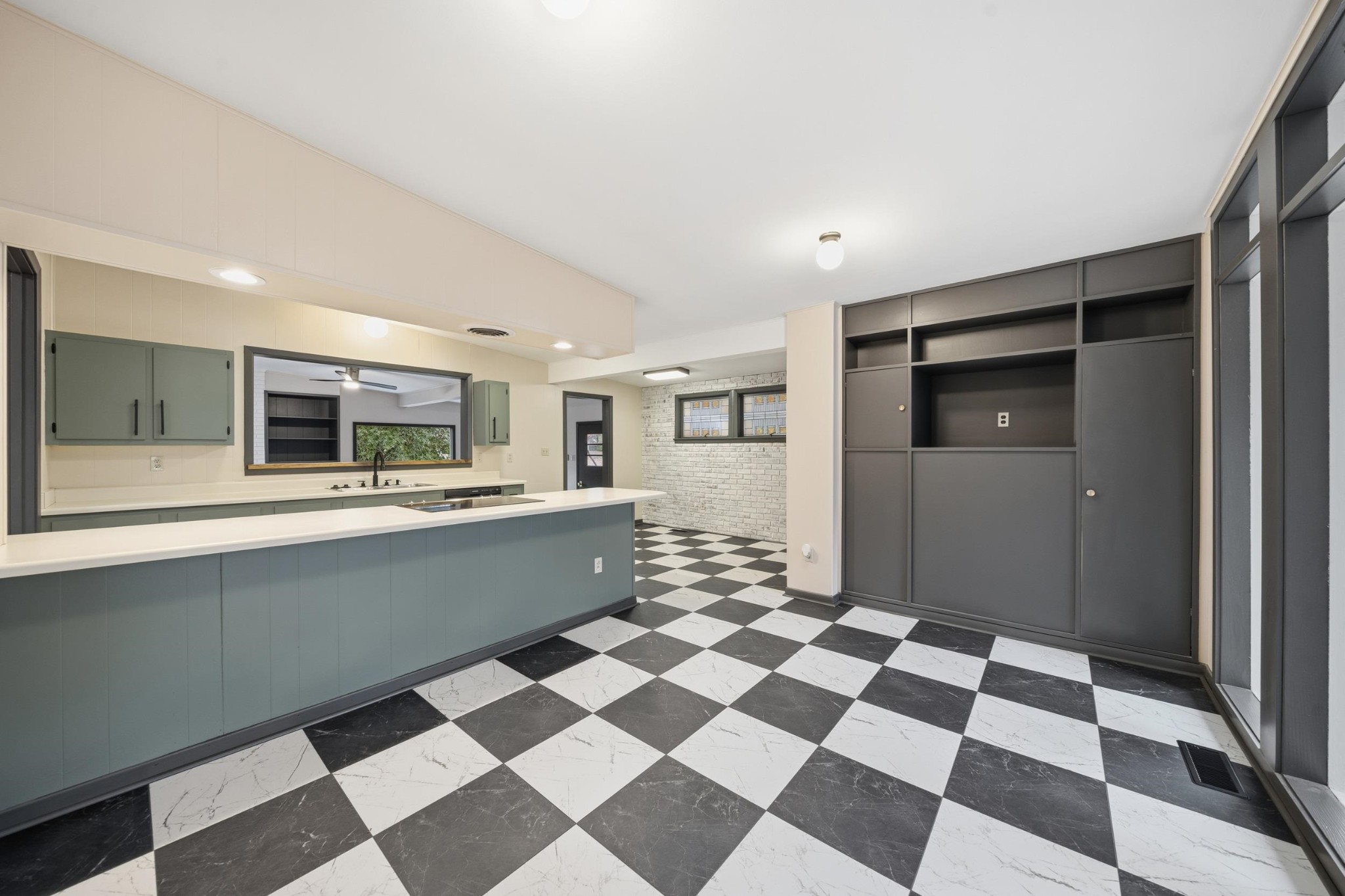 2534 Elmore Park Road Memphis, TN 38134 - Photo 8 of 35 a large white kitchen with a checkered floor and a fireplace