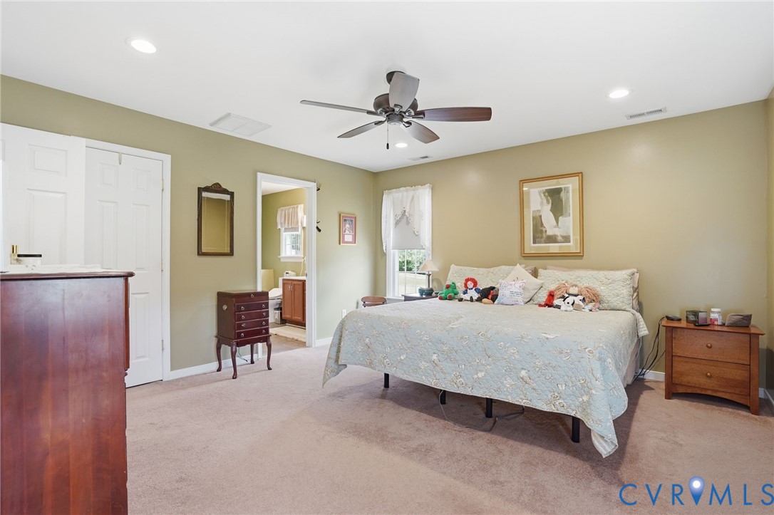 19012 Teman Road Beaverdam, VA 23015 - Photo 17 of 41 a bedroom with a bed and a chandelier