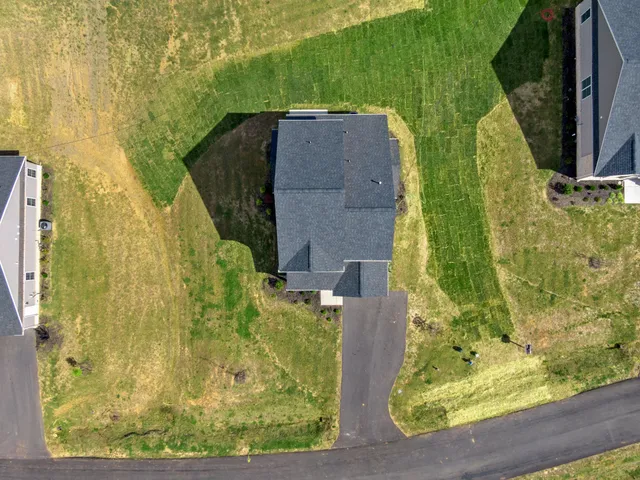 a front view of a house with a yard and balcony