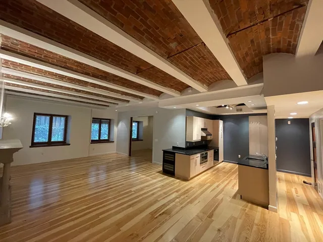 a view of kitchen with furniture and wooden floor