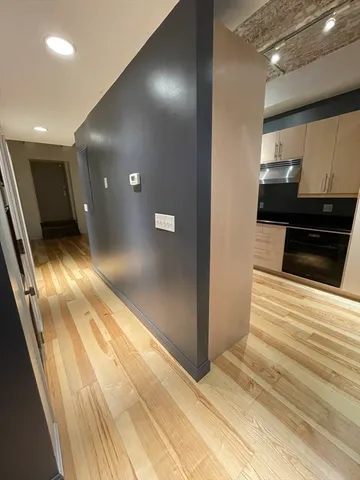 a view of a hallway with wooden floor