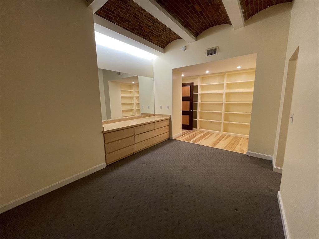 61 Prince Street, Unit 1C Boston, MA 02113 - Photo 14 of 26 a view of an empty room with a fireplace and a window
