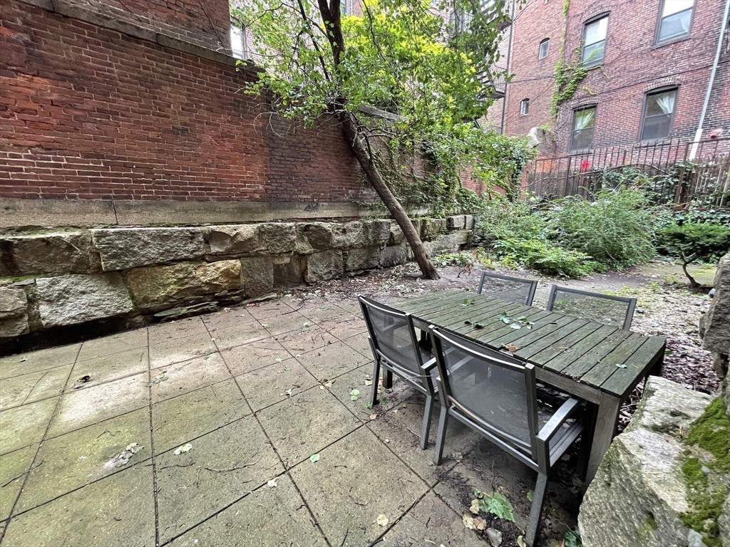 61 Prince Street, Unit 1C Boston, MA 02113 - Photo 19 of 26 a roof deck with table and chairs and potted plants