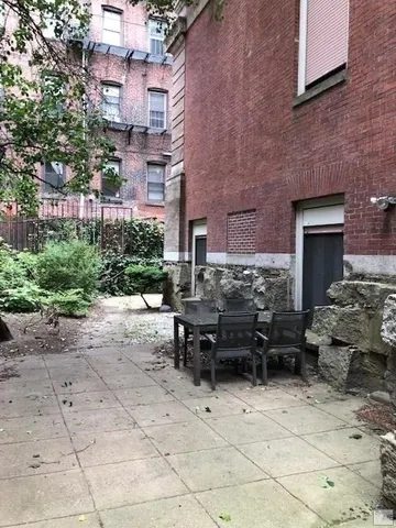 a backyard of a house with potted plants
