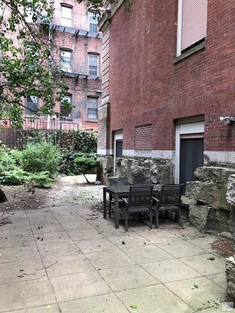 61 Prince Street, Unit 1C Boston, MA 02113 - Photo 20 of 26 a backyard of a house with potted plants