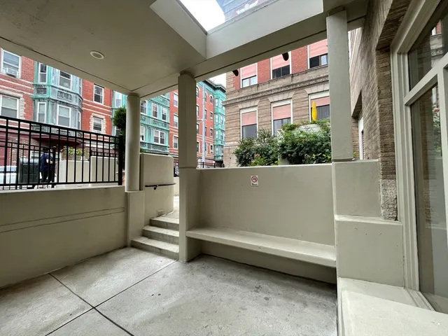 a view of backyard with a large window and a white door
