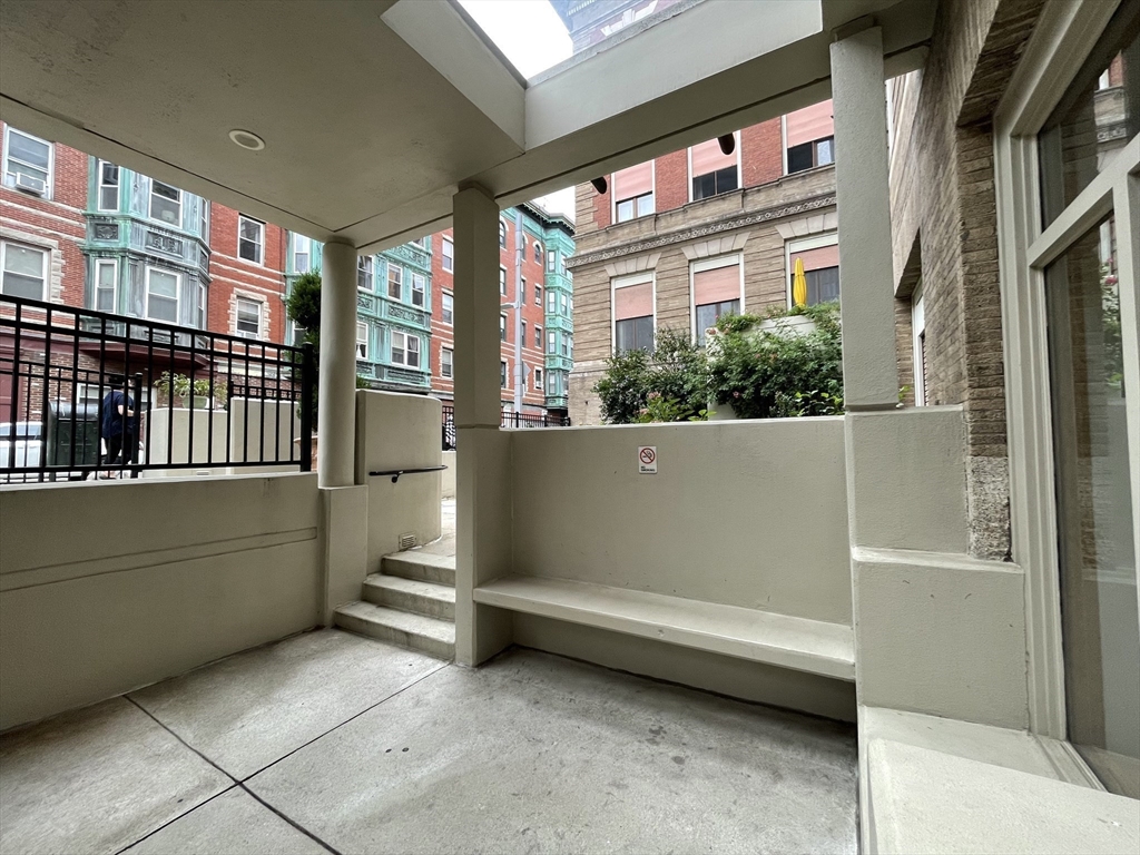 61 Prince Street, Unit 1C Boston, MA 02113 - Photo 22 of 26 a view of backyard with a large window and a white door