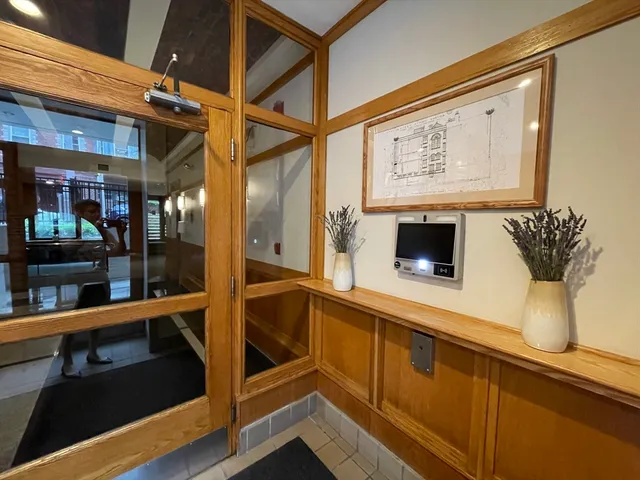 a view of a living room with a large window and furniture