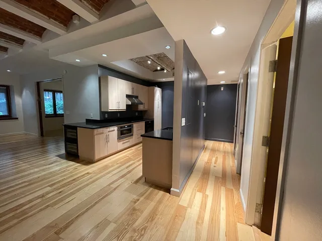 a open kitchen with stainless steel appliances granite countertop a refrigerator and a sink