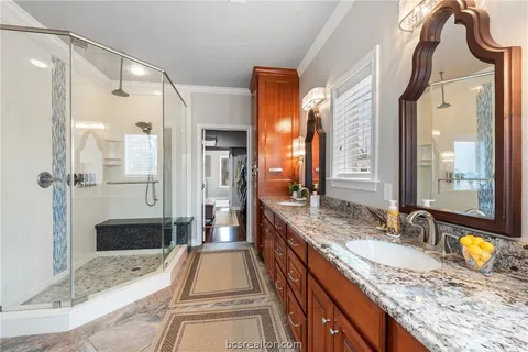 a bathroom with a granite countertop sink mirror bathtub and shower