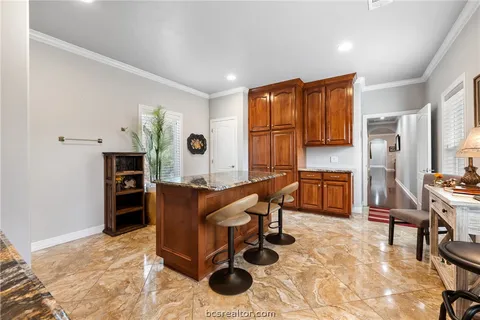 a living room with furniture a dining table and kitchen view with wooden floor