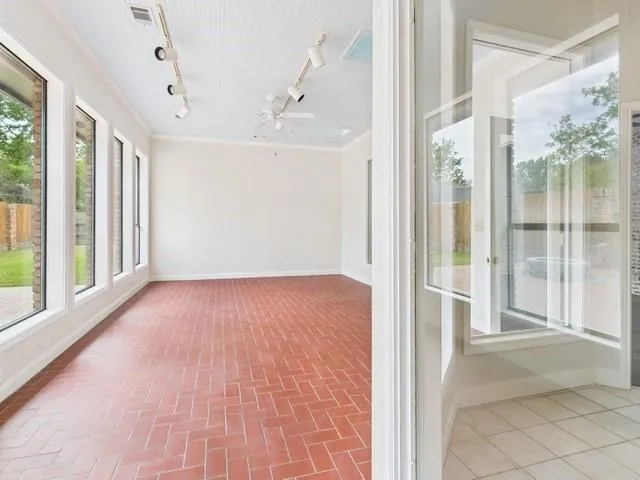a view of a hallway with wooden floor and windows