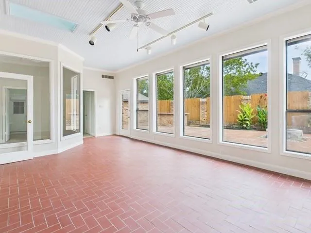an empty room with windows and outdoor view
