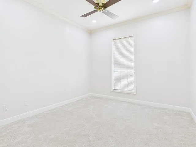 a spacious en suite spacious bathroom with a double vanity sink a mirror and a bathtub