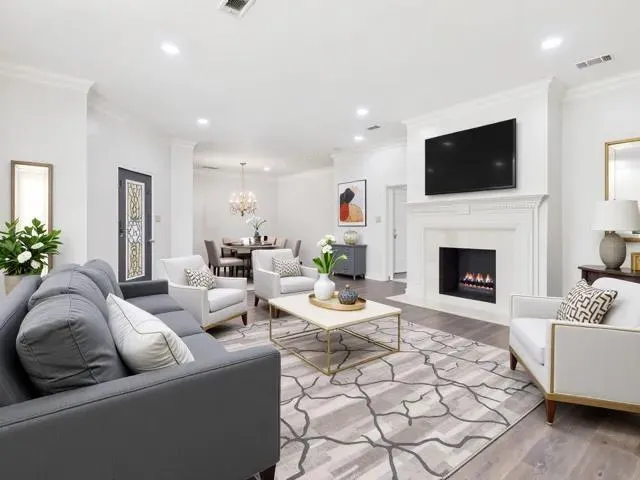 a view of a dining room with furniture a chandelier and a window