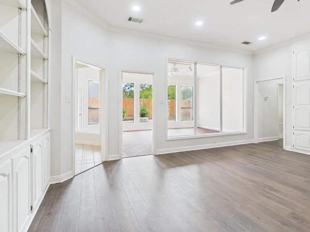 a view of wooden floor and windows in a room