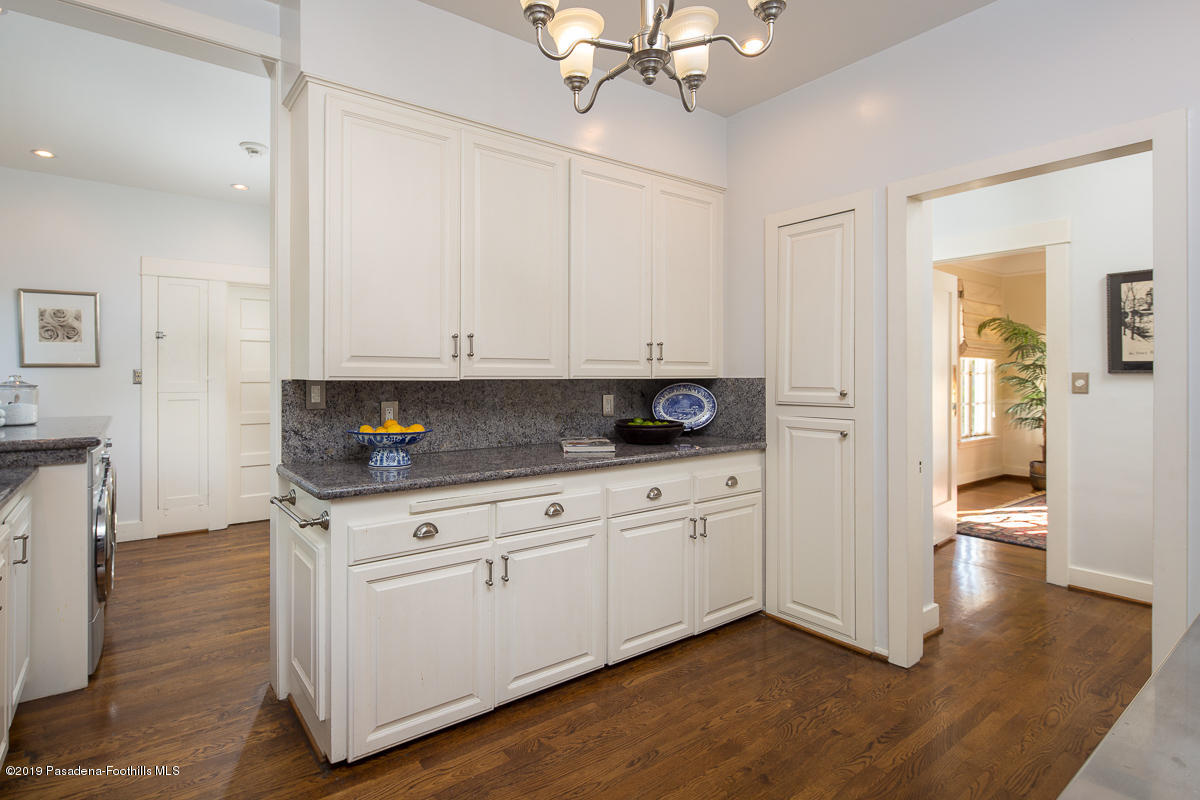 155 Club Road Pasadena, CA 91105 - Photo 24 of 50 a kitchen with stainless steel appliances granite countertop a stove a sink and white cabinets with wooden floor
