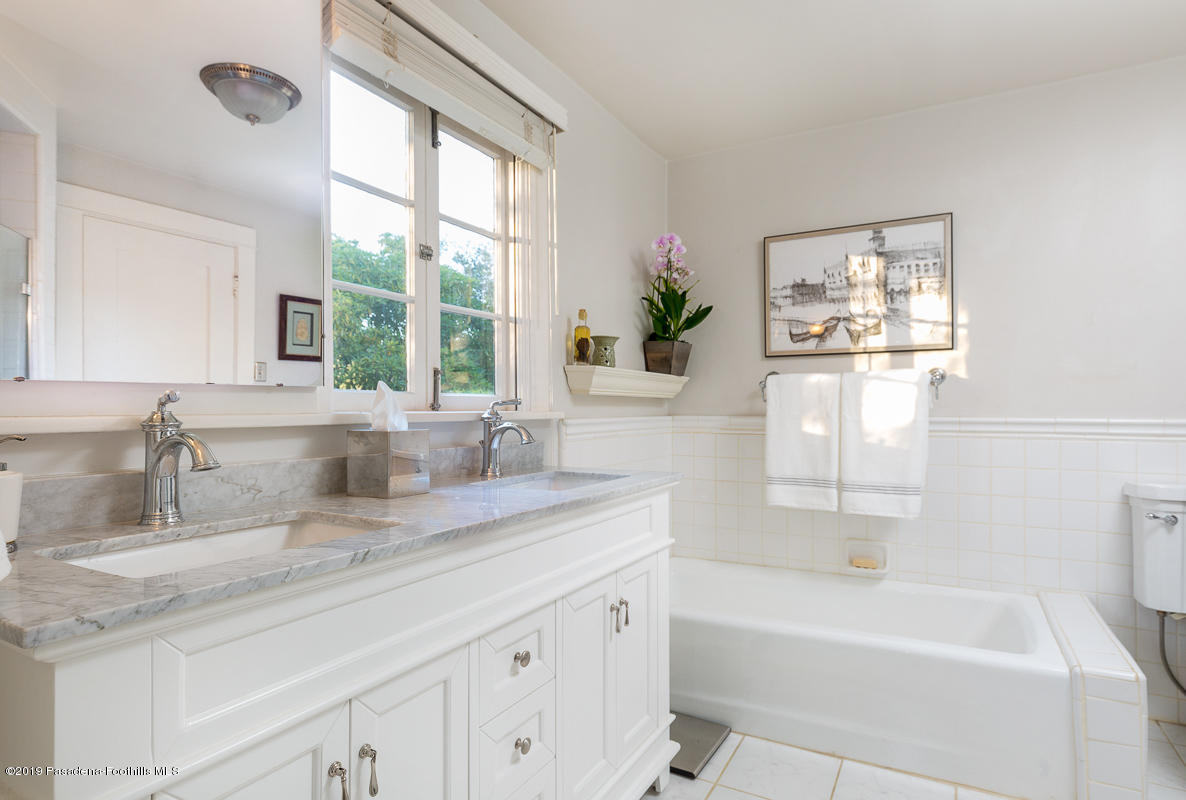 155 Club Road Pasadena, CA 91105 - Photo 35 of 50 a bathroom with a granite countertop sink mirror bathtub and next to a window