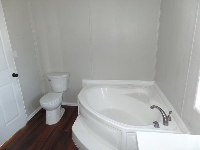 178 Valley Lake Lane Springtown, TX 76082 - Photo 13 of 25 a bathroom with a white toilet and a bathtub