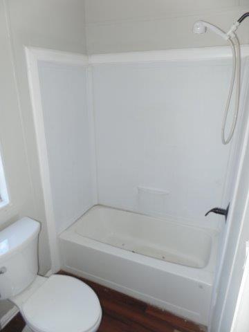 178 Valley Lake Lane Springtown, TX 76082 - Photo 15 of 25 a bathroom with a toilet and a bathtub