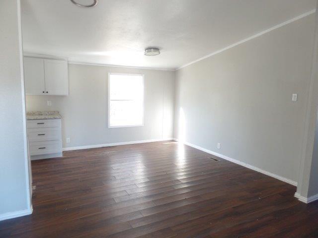 178 Valley Lake Lane Springtown, TX 76082 - Photo 4 of 25 an empty room with wooden floor and windows