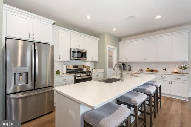a kitchen with a sink stainless steel appliances and cabinets