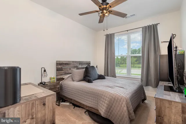 a bedroom with furniture and a flat screen tv