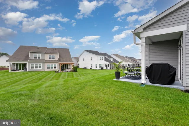 a front view of house with yard and outdoor seating