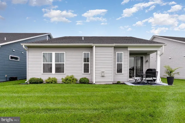 a living room with furniture a fireplace and a chandelier
