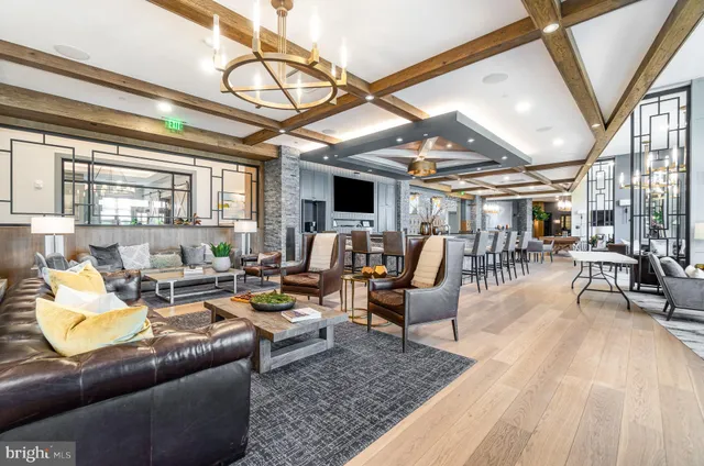 a kitchen with a dining table and chairs with wooden floor