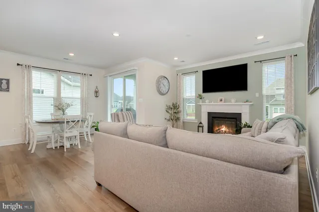 a dining room with furniture wooden floor and a potted plant