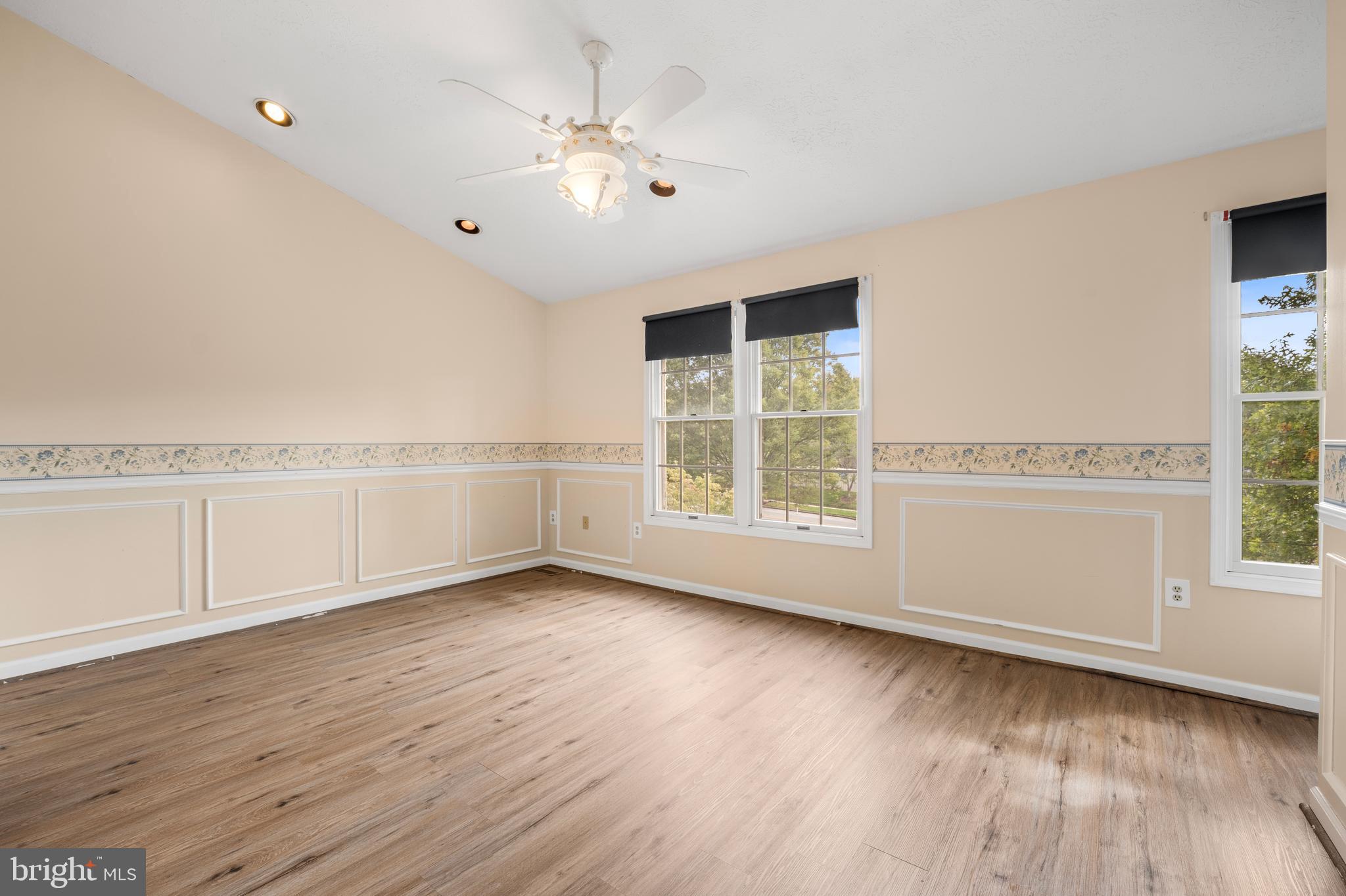 5522 April Journey, Unit 11 Columbia, MD 21044 - Photo 17 of 34 an empty room with wooden floor and windows