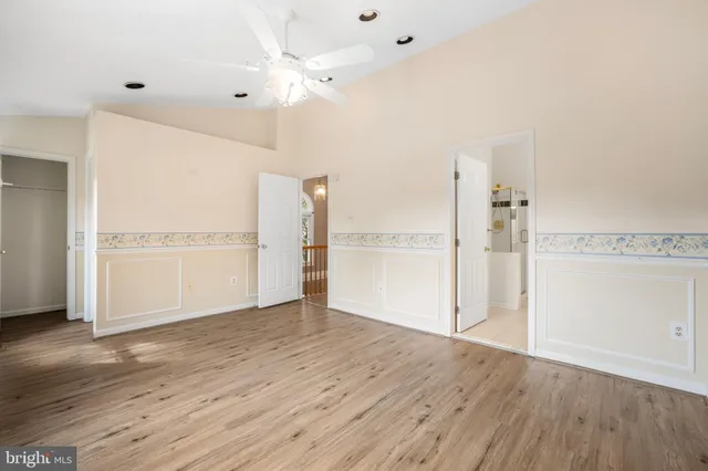 a view of empty room with wooden floor