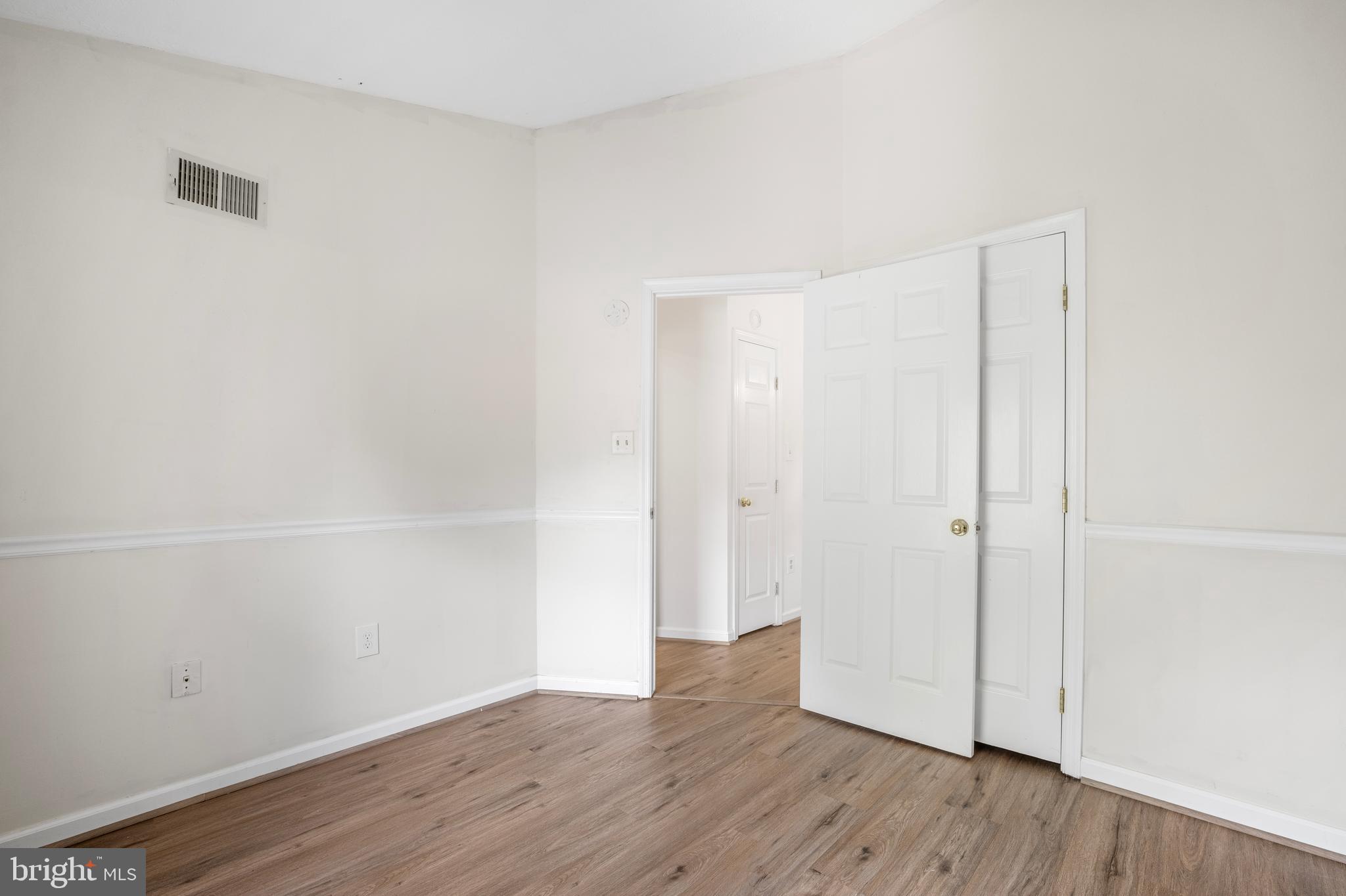 5522 April Journey, Unit 11 Columbia, MD 21044 - Photo 22 of 34 a view of an empty room with wooden floor