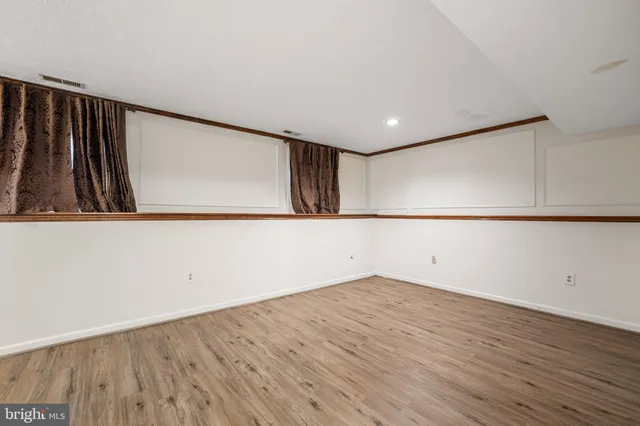 a view of a room with wooden floor